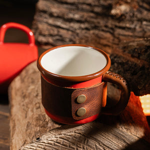 Brass hardware snaps on leather wrapped enamel adventure cup, premium metal fasteners detail