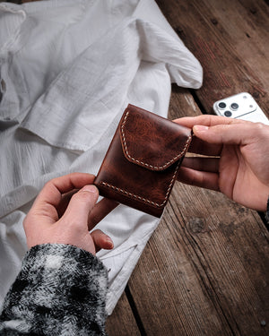 Dogaart Athen brown waxed pull up leather wallet held showing distinctive grain patterns and natural markings