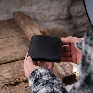 Dogaart Rio name engraved black crazy leather wallet closed hand holding view displaying elegant design