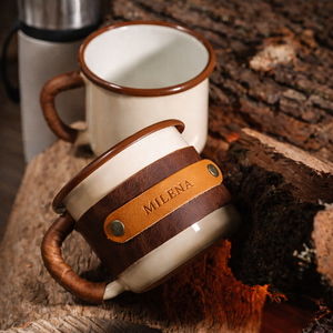Premium leather wrapped enamel mug alongside plain metal mug showing handcrafted sleeve benefits, side by side