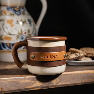 Metal enamel adventure cup 330ml with premium leather sleeve and brass details, straight front angle