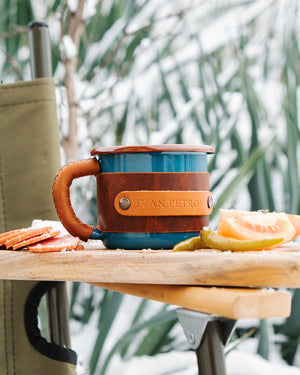 Outdoor metal mug with ergonomic handle and leather protection for camping adventures, outdoor proportional view