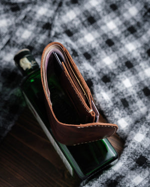 Dogaart Athen brown waxed pull up leather wallet edge closeup revealing design details and grain structure