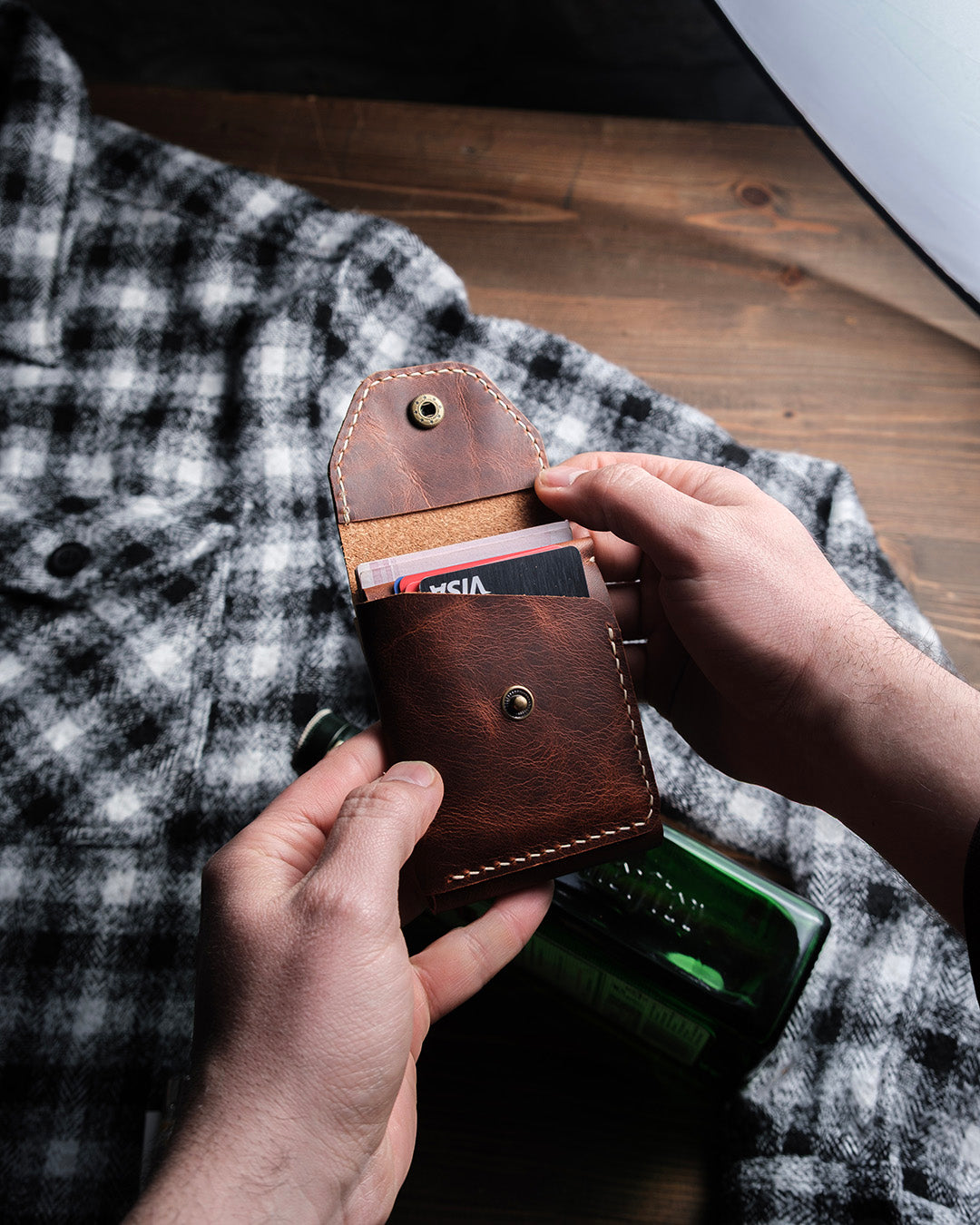 Dogaart Athen brown waxed pull up leather wallet held in hand with snap closure open displaying interior