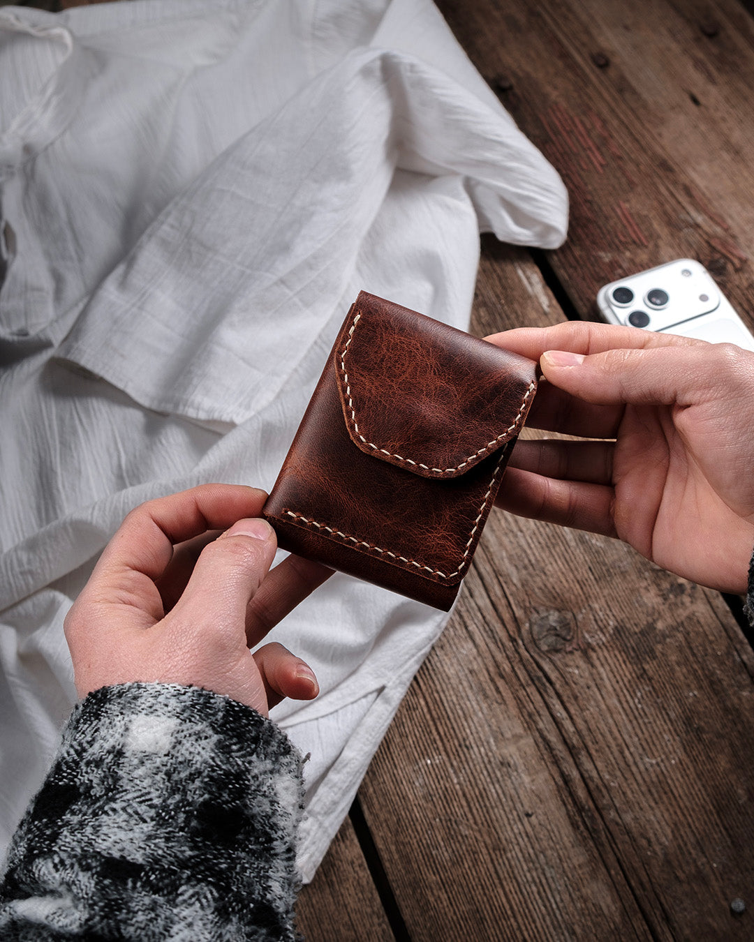 Dogaart Athen brown waxed pull up leather wallet held showing distinctive grain patterns and natural markings