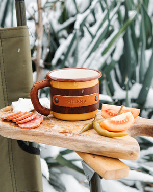 Dogaart yellow leather mug photographed outdoors in natural lighting showing rugged camping drinkware appeal