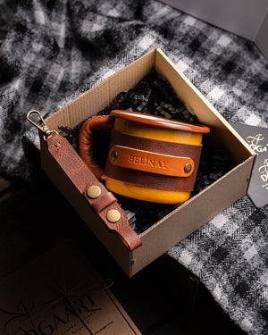 Dogaart yellow leather-wrapped enamel mug displayed inside premium gift box packaging with product details visible