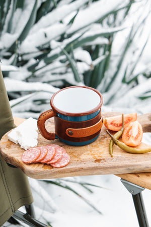 Adventure cup 330ml featuring brass hardware and leather wrap with clean enamel interior, top interior view
