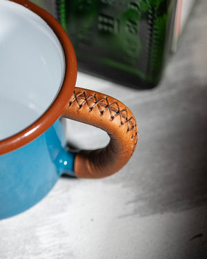 Handcrafted adventure cup with premium leather handle wrap showcasing detailed stitching work, handle close-up view