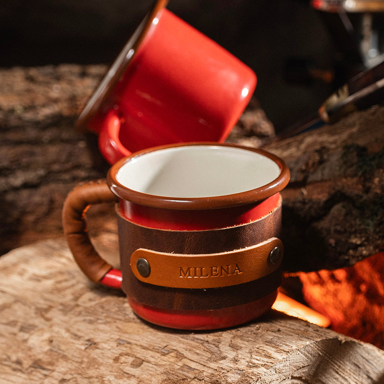 Handcrafted leather wrapped enamel mug with brass hardware details, premium leather sleeve close-up