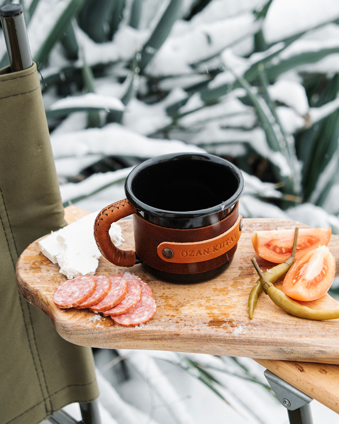 Rustic enamel mug with leather wrapping, ideal for camping and outdoor adventures, aerial view
