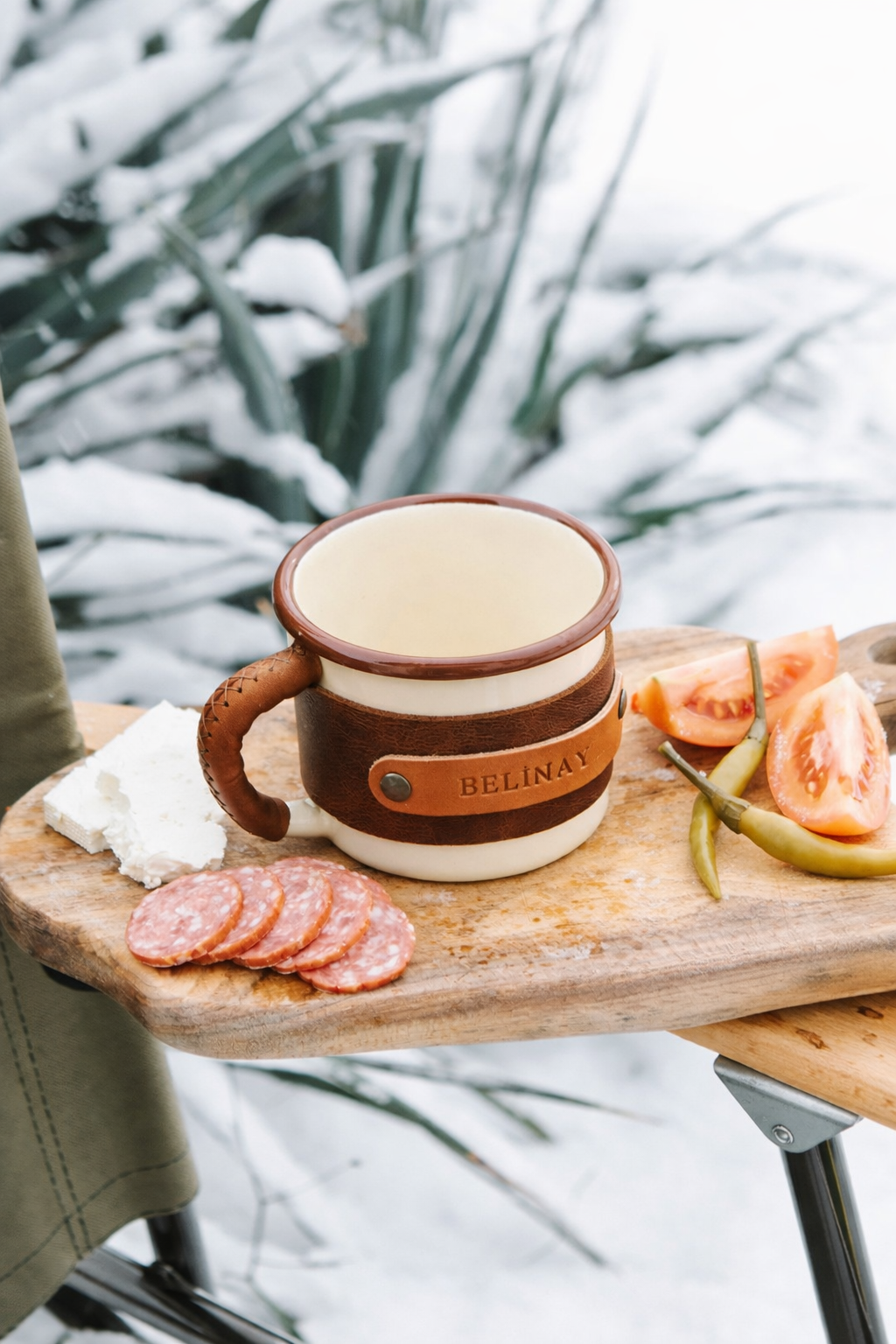Outdoor gear enamel mug 330ml with brass hardware and leather wrap, top-down interior view